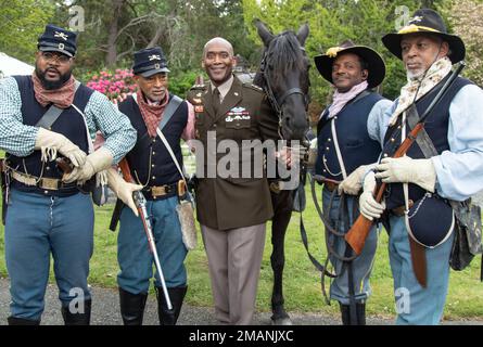 A new Buffalo Soldier exhibit commemorating the 1904 Ninth Cavalry encampment was formally dedicated at the DuPont Historical Museum, DuPont, Wash., June 1, 2022. Pictured is Lt. Gen. Xavier Brunson, center, posing with the Buffalo Soldiers of Seattle and their horse following the dedication ceremony. Stock Photo