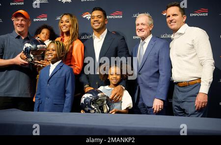 Denver Broncos quarterback Russell Wilson (3) greets, from left to right,  his daughter Sienna, wife and rap star Ciara, and sons Future and Win  before taking part in drills during the NFL