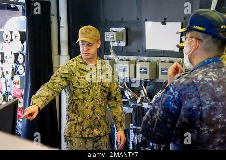220601-O-NR876-639  SASEBO, Japan (June 1, 2022) Chief Fire Controlman Jesse Boles, from Little Rock, Arkansas, explains to Japan Maritime Self-Defense Force Rear Adm. SHIMIZU Hitoshi, commander, Escort Flotilla Two, the functionality and capabilities of the Naval Strike Missiles, and how they enhance the lethality of the Independence-class littoral combat ship USS Charleston (LCS 18). Charleston, part of Destroyer Squadron (DESRON) 7, is on a rotational deployment, operating in the U.S. 7th Fleet area of operations to enhance interoperability with partners and serve as a ready-response force Stock Photo