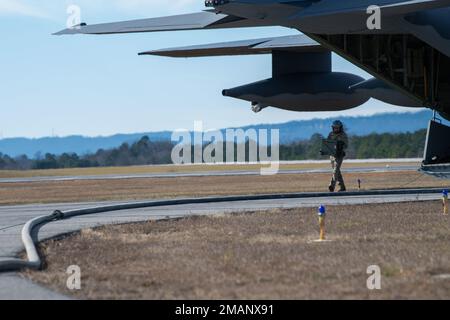 U.S. Air Force Master Sgt. Derek Watson, an aerial gunner with the 4th Special Operations Squadron, carries ammo from an MC-130J Commando II assigned to the 15th Special Operations Squadron at Hurlburt Field, Fla., during a Forward Area Refueling point exercise in Gadsden, Ala., Jan 6, 2023. In addition to refueling an AC-130J Ghostrider gunship, crews simulated exchanging ammo as part of the FARP exercise. (U.S. Air Force photo by Senior Airman Natalie Fiorilli) Stock Photo