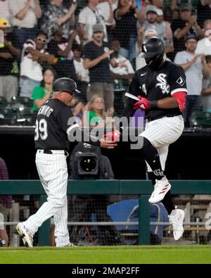 Chicago White Sox's Luis Robert passes third base coach Joe McEwing and  celebrates his two-run homer off Toronto Blue Jays starting pitcher Jose  Berrios during the third inning of a baseball game