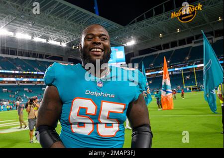 Miami Dolphins offensive lineman Robert Jones smiles on the field