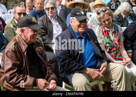 World War II veterans share a laugh after being presented a challenge coin for their service by Lt. Gen. John Kolasheski, Commanding Officer V Corps, during a ceremony held at the Eternal Heroes Memorial honoring members of the 101st and 82nd Airborne Divisions killed in the liberation of Ravenoville. This year, U.S. Army Europe and Africa commemorates the 78th anniversary of DDay, the largest multinational amphibious landing and operational military airdrop in history, and highlights the U.S.' steadfast commitment to European allies and partners. Stock Photo