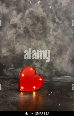 Red lighted heart on a black bacground. Copy space Stock Photo