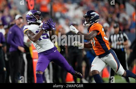 Minnesota Vikings wide receiver Ihmir Smith-Marsette (15) pulls in a pass  as Denver Broncos cornerback Donnie Lewis Jr. (39) covers during an NFL  preseason football game, Aug. 28, 2022, in Denver. (AP