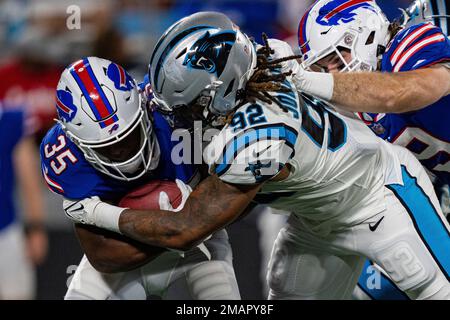 Buffalo Bills running back Duke Johnson (22) attempts to avoid the tackle  by Carolina Panthers cornerback Kalon Barnes (35) during an NFL preseason  football game on Friday, Aug. 26, 2022, in Charlotte