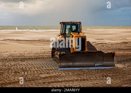 Bulldozer prepares the sea beach for the season Stock Photo