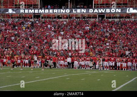 Fans have their photos made while standing next to the jersey of former  Kansas City Chiefs quarterback Len Dawson before the start of an NFL  preseason football game Thursday, Aug. 25, 2022