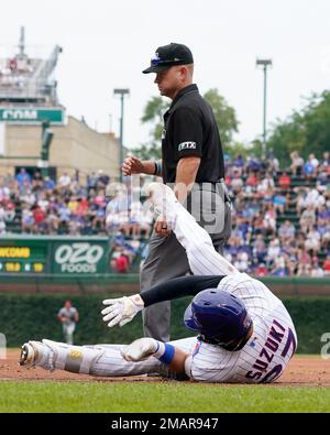 The Chicago Cubs' Seiya Suzuki (R) is congratulated by first base coach  Mike Napoli after hitting an RBI single in the fourth inning of a baseball  game against the Pittsburgh Pirates on