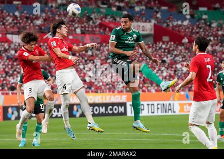 Al Hilal's Ali Al Bulayhi, right, fights for the ball with Urawa