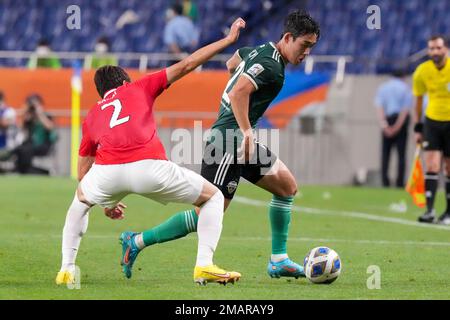 Al Hilal's Ali Al Bulayhi, right, fights for the ball with Urawa