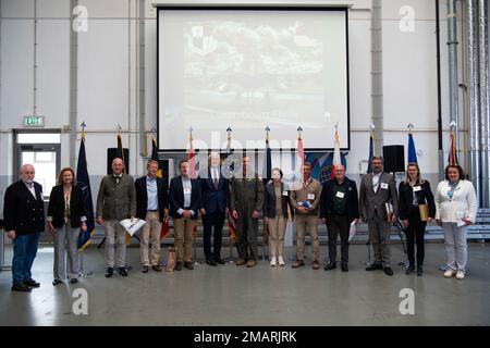 Col. Leslie Hauck, center, 52nd Fighter Wing commander, poses with visitors, including multiple ambassadors from NATO countries at Spangdahlem Air Base, Germany, June 3, 2022. NATO promotes democratic values and diplomacy; and enables members to consult and cooperate on defense and security-related issues, to build trust and, ultimately, to prevent conflict. 52 FW,DOD,NATO,europeansupport2022,partnerships, Stock Photo