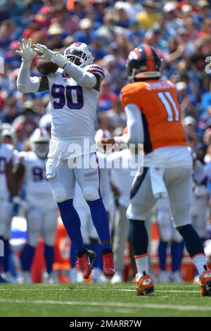 Buffalo Bills' Shaq Lawson, left, greets Denver Broncos' DeShawn