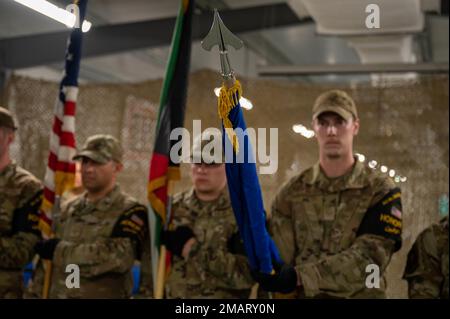 Ali Al Salem Base Honor Guard members present the 387th Expeditionary Security Forces Squadron flag during the 387th ESFS inactivation ceremony at Cargo City, Kuwait, June 3, 2022. Lt. Col. Bruce Lewis, outgoing commander of the 387th ESFS, led 105 active, reserve, guard and Department of Defense contractor personnel providing security and force protection to over 400 U.S. and coalition forces. Stock Photo