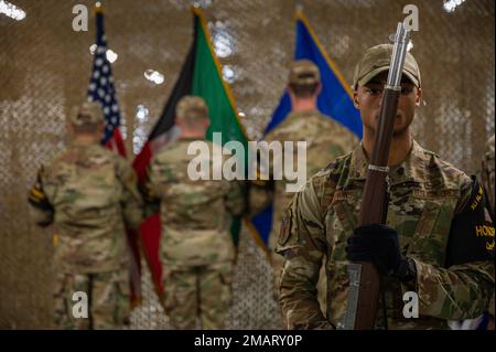 Ali Al Salem Base Honor Guard members post the colors during the 387th Expeditionary Security Forces Squadron inactivation ceremony at Cargo City, Kuwait, June 3, 2022. Lt. Col. Bruce Lewis, outgoing commander of the 387th ESFS, led 105 active, reserve, guard and Department of Defense contractor personnel providing security and force protection to over 400 U.S. and coalition forces. Stock Photo