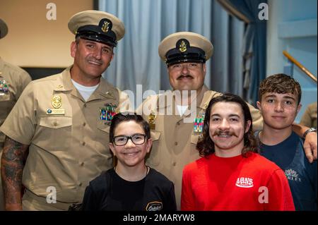 Senior Chief Master-at-Arms Tony Vuono was pinned by his sons Avery, Ayden, and Ashton during the aircraft carrier Pre-Commissioning Unit John F. Kennedy (CVN 79) pinning ceremony. The rank of senior chief and master chief was created June 1, 1958, under an amendment to the Career Compensation Act of 1949. John F. Kennedy is the second Ford-class aircraft carrier and is under construction at the Huntington Ingalls Industries Newport News Shipyard. Stock Photo