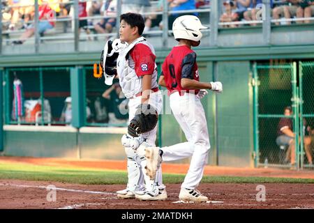 Canada's Braedyn Lai Hainstock (9) scores past Japan catches Zakuto  Tsuchiya on Jaxon Mayervich's single during the sixth inning of a baseball  game at the Little League World Series tournament in South Williamsport,  Pa., Friday, Aug. 19, 2022. Canada