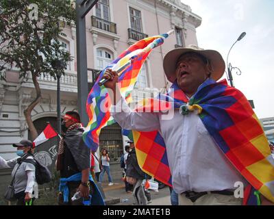 An indigenous man waving the Wiphala, the flag of the Andean peoples, when thousands of protesters, coming from all over the country, mostly peasants, unionists, indigenous people and students, took to the streets of Lima to demand the resignation of President Dina Boluarte. The protests in the capital and especially in the south of Peru have not stopped since Boluarte assumed the presidency on December 7th, and to date there have been more than 40 deaths. Credit: Fotoholica Press Agency/Alamy Live News Stock Photo