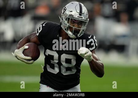 Miami Dolphins linebacker Cameron Goode (53) tackles Las Vegas Raiders  running back Brittain Brown (38) during the second half of a NFL preseason  football game, Saturday, August 20, 2022, in Miami Gardens