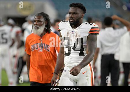Cleveland Browns run game coordinator/running backs coach Stump Mitchell,  left, and running back Jerome Ford (34) leave the field after a preseason  NFL football game against the Jacksonville Jaguars, Friday, Aug. 12, 2022,  in Jacksonville, Fla. (AP ...