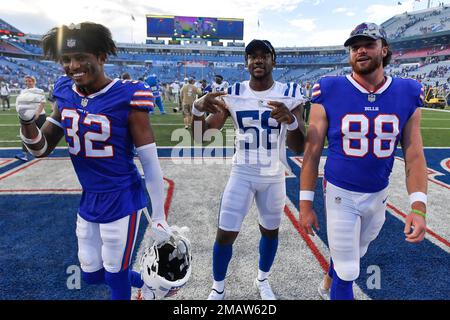 Buffalo Bills defensive back Jordan Miller, left, and tight end Dawson  Knox, right, walk off the field with Indianapolis Colts linebacker Bobby  Okereke after a preseason NFL football game in Orchard Park, N.Y.,  Saturday, Aug. 13, 2022. The Bills defeat