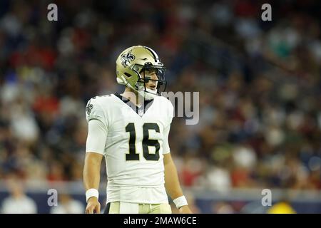 New Orleans Saints quarterback Ian Book (16) is slow to get up aft he was  sacked by Houston Texans defensive tackle Thomas Booker IV (56) during the  second half of an NFL