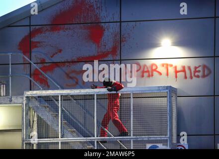 Edinburgh, UK. 19th Jan, 2023. A Palestine Actionist sprays paint messages outside the building during the demonstration. Palestine Activists cut the security fence in the dead of the night and get on the roof of arms factory Leonardo in Edinburgh. They are protesting and highlighting the fact that Leonardo are providing laser guidance systems for Israeli F35 combat aircraft and Hermes 450 drones. These munitions are used against the Palestinian people in Gaza and elsewhere. (Photo by Martin Pope/SOPA Images/Sipa USA) Credit: Sipa USA/Alamy Live News Stock Photo