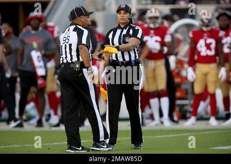 Baltimore Ravens wide receiver Tylan Wallace (16) makes a reception at the  sideline, but field judge James Coleman (95) watches Wallace's right foot  lift as the pass was caught, for an incomplete