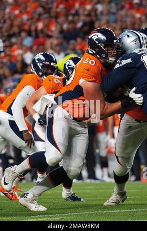 Denver Broncos running back Jaleel McLaughlin (38) runs into Denver Broncos  center Luke Wattenberg (60) in