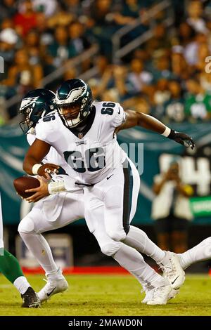 Philadelphia Eagles center Cameron Tom (66) recovers a fumble by  Philadelphia Eagles quarterback Reid Sinnett (not shown) and is tackled by Miami  Dolphins defensive tackle Niles Scott (70) and Miami Dolphins linebacker