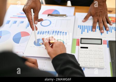 close-up image, Professional Asian financial consultants or analysts brainstorming and working together on their financial report. Stock Photo