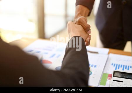 close-up image, Two professional and successful Asian businesspeople shaking hand in the financial meeting. Stock Photo