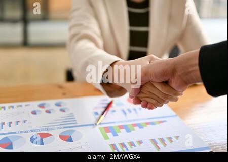 close-up hand image, Two successful businesspeople shaking hands after close the business deal. Stock Photo