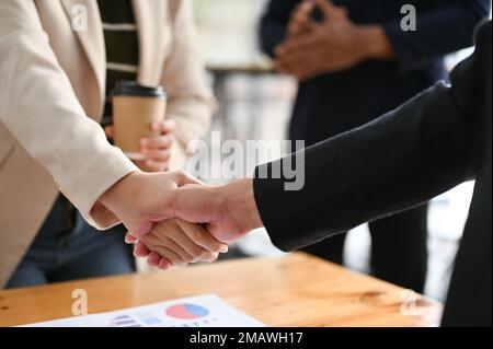 close-up image, A female manager shaking hand with her new employee, congratulations or welcoming new stuff. Stock Photo