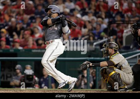 Washington Nationals' Nelson Cruz, left, walks past Texas Rangers starting  pitcher Dane Dunning, right, on his way to the dugout after being thrown  out at home while trying to score on a