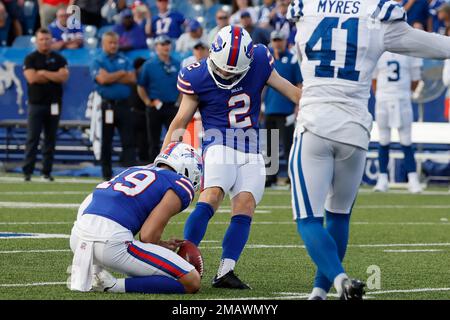 Buffalo Bills kicker Tyler Bass, right, kicks a field goal from the hold of  punter Sam Martin during the first half an NFL preseason football game  against the Indianapolis Colts in Orchard