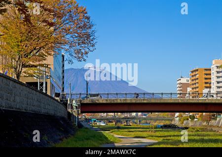 Mount Iwate scene with buildings and promenade at Katakami river in  Morioka city, Iwate prefecture, Tohoku, Japan. Stock Photo