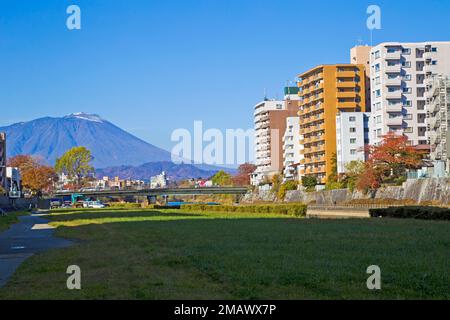 Mount Iwate scene with buildings and promenade at Katakami river in  Morioka city, Iwate prefecture, Tohoku, Japan. Stock Photo