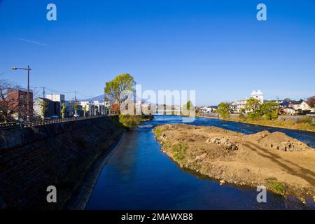 Mount Iwate scene with buildings and promenade at Katakami river in  Morioka city, Iwate prefecture, Tohoku, Japan. Stock Photo