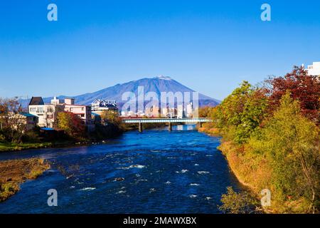 Mount Iwate scene with buildings and promenade at Katakami river in  Morioka city, Iwate prefecture, Tohoku, Japan. Stock Photo