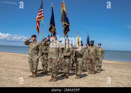 U.S. Army Soldiers assigned to 1st Battalion, 8th Infantry Regiment, 4th Infantry Division render a salute on the coast of Utah Beach in honor of the unit’s heritage, June 6, 2022, during the 78th Commemoration Ceremonie de Utah Beach, at Utah Beach, Normandie, France. The 4th Inf. Div. assaulted the northern coast of German-held France during the Normandy landings, landing at Utah Beach. The 8th Infantry Regiment of the 4th Inf. Div. claimed to be the first surface-borne Allied unit to hit the beaches at Normandy on D-Day, June 6, 1944, which was 78 years ago. Stock Photo