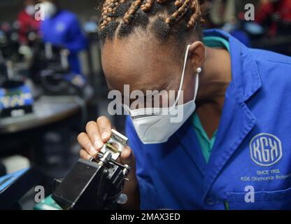 Gaborone, Botswana. 18th Jan, 2023. An employee of KGK Diamonds Botswana inspects a diamond in Gaborone, Botswana, Jan. 18, 2023. Botswanan President Mokgweetsi Masisi said Wednesday that developing raw materials value chains allows for innovation and builds sustainability, particularly in the diamond industry. TO GO WITH 'Botswanan president says diamond value chains critical to Botswana's economic diversification' Credit: Tshekiso Tebalo/Xinhua/Alamy Live News Stock Photo