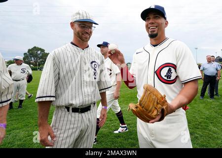 Field of Dreams ghost player Russ Bolibaugh, left, of Dyersville, Iowa,  talks with Chicago Cubs center fielder Rafael Ortega, right, before a  baseball game against the Cincinnati Reds at the Field of Dreams movie  site, Thursday, Aug. 11, 2022, in Dyers
