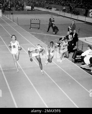 Bob Hayes of Florida A&M, who has equaled the world indoor record for the  60-yard dash, puts his nose to the tape to barely escape an upset in the  60-yard dash at