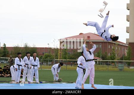 A Korean Taekwondo demonstration team begin the KATUSA Friendship Week ceremony with a martial arts performance on Camp Humphreys, Republic of Korea, 7 June, 2022. KATUSA Friendship Week is hosted annually to facilitate unit cohesion, solidify friendship and foster a cultural understanding between both countries. Stock Photo