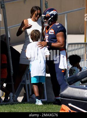 Denver Broncos quarterback Russell Wilson (3) is greeted by his 5-year-old  daughter Sienna, second from left, as stepson Future, left, son Win, third  from left, and wife, rap star Ciara, right, look on as he heads to the  playing field to take part in d