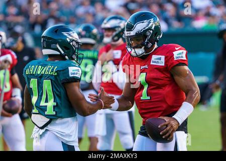 Member of the US military holds up the signed practice worm jersey of  Philadelphia Eagles quarterback Jalen Hurts for the Back Together  Saturday during practice at NFL football training camp, Saturday, July