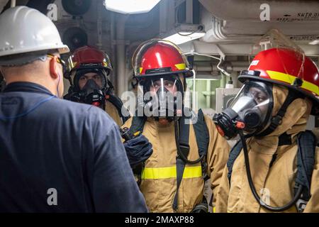 SASEBO, Japan (June 7, 2022) Sailors assigned to the forward-deployed amphibious assault ship USS America (LHA 6) participate in a damage control exercise in one of the ships engine rooms. America, lead ship of the America Amphibious Ready Group, is operating in the U.S. 7th Fleet area of responsibility to enhance interoperability with allies and partners and serve as a ready response force to defend peace and stability in the Indo-Pacific region. Stock Photo