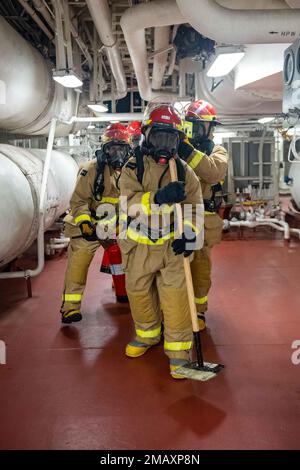 SASEBO, Japan (June 7, 2022) Sailors assigned to the forward-deployed amphibious assault ship USS America (LHA 6) participate in a damage control exercise in one of the ships engine rooms. America, lead ship of the America Amphibious Ready Group, is operating in the U.S. 7th Fleet area of responsibility to enhance interoperability with allies and partners and serve as a ready response force to defend peace and stability in the Indo-Pacific region. Stock Photo
