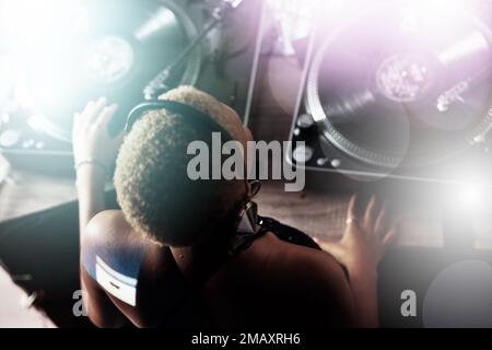 Black woman, DJ and music for party, club or event in celebration, sound or energy with technology. African American female musician with turntable Stock Photo